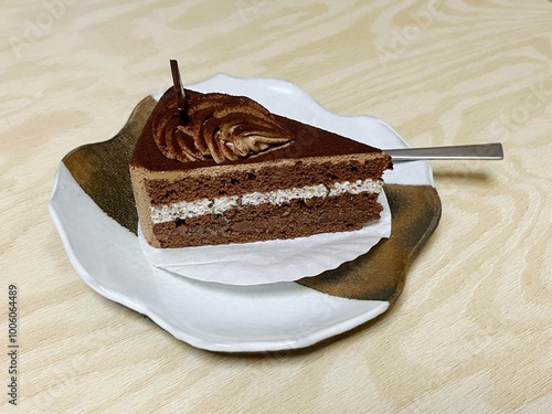 Fresh cream chocolate cake on wood table