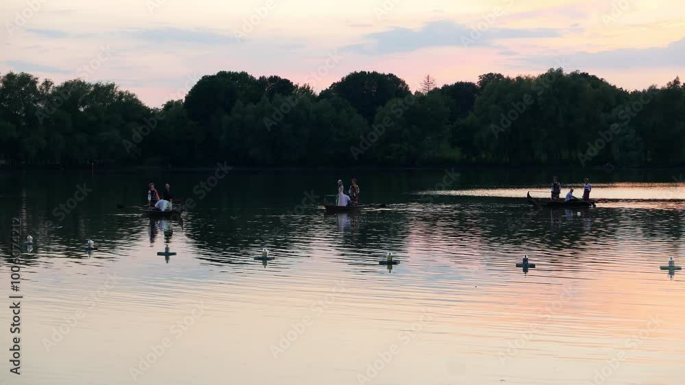 Theatrical Ukrainian folk festival gala day of Ivan Kupala. Ukrainian people sail on boats on the lake. Theatrical Ukrainian folk festival gala day of Ivan Kupala. Ukrainian people sail on boats on the lake.