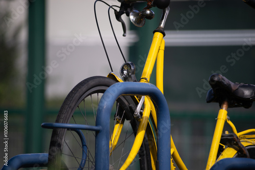 yellow bicycle at public bike rack photo