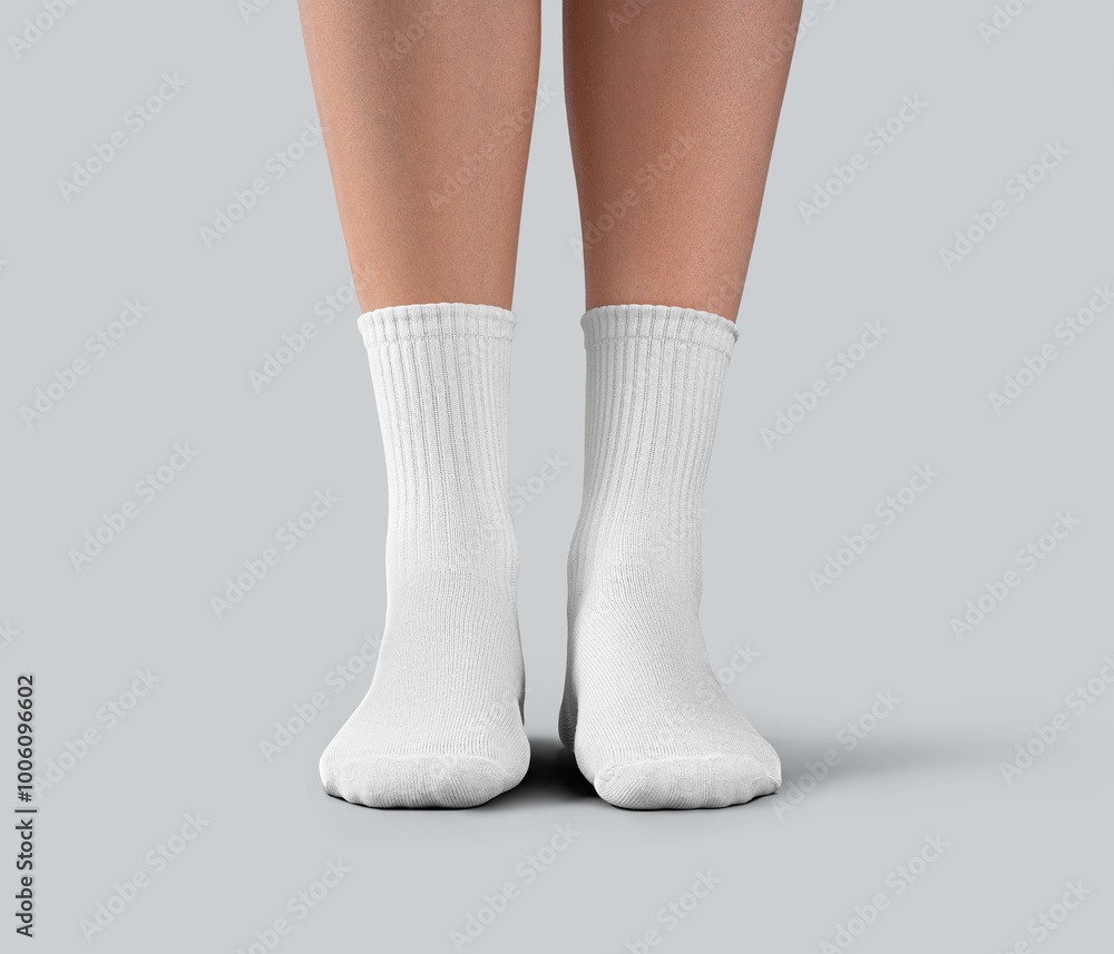 Mockup of white medium socks on a female foot, isolated on background, front view. Mockup of white medium socks on a female foot, isolated on background, front view.