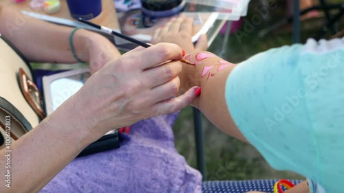 Women draw body art on their hands photo