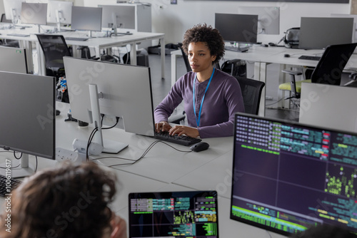 African American female coder working on computer software photo