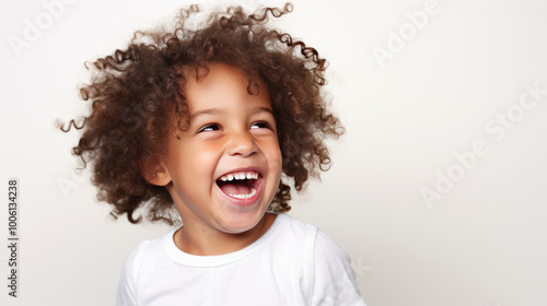 Joyful Curly-Haired Toddler Laughing with Delight