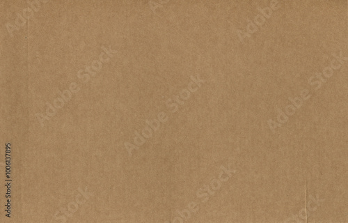Kraft brown texture paper. Rough cardboard with fiber inclusions. Grunge backdrop and background