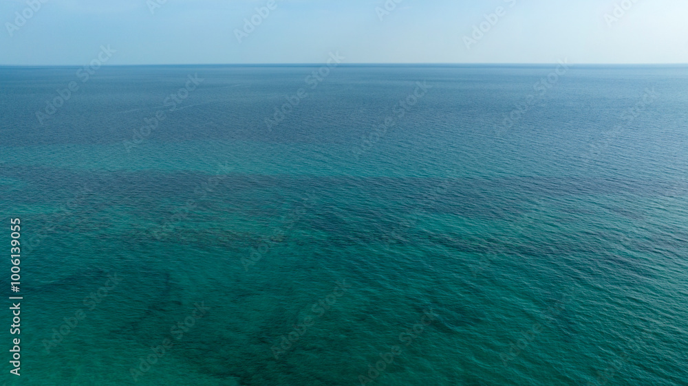 Aerial view of the sea that reaches the horizon. The surface of the water is calm and there are no ships. Aerial view of the sea that reaches the horizon. The surface of the water is calm and there are no ships.