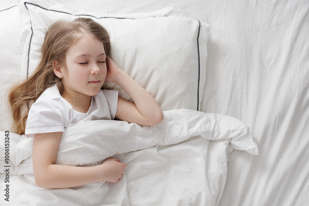 cute little girl sleeping in bed under blanket, copy space cute little girl sleeping in bed under blanket, copy space