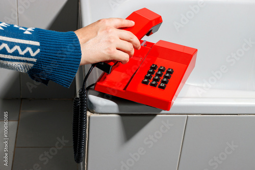 Woman with red retro telephone in vintage style bathroom. photo