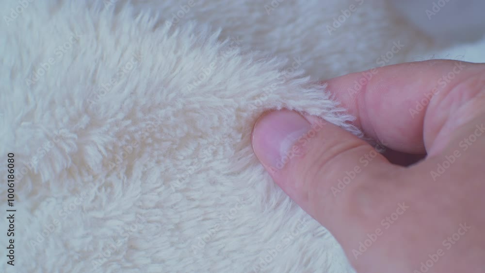 A customer checks the quality of a faux fur product with his hand. Close-up A customer checks the quality of a faux fur product with his hand. Close-up