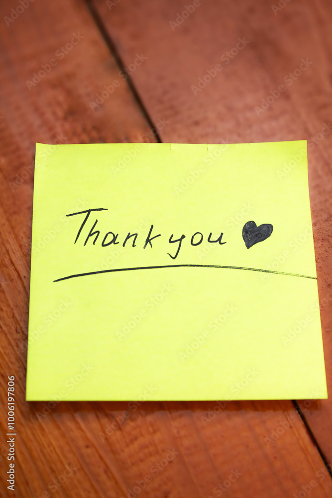 Thank you handwritten, on yellow paper, with a heart symbol Thank you handwritten, on yellow paper, with a heart symbol