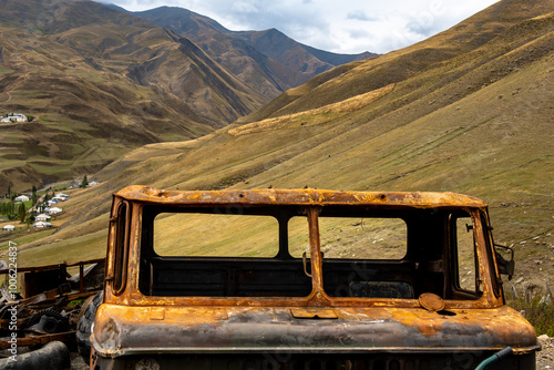 Khinalug, Azerbaijan A rusty and broken down truck and the Qudyalchay River valley below. photo