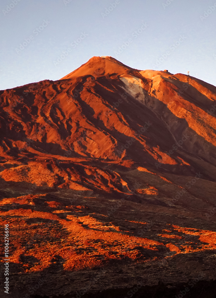 Naklejka premium A volcano Teide and stunning mountains with lava formations at sunset/