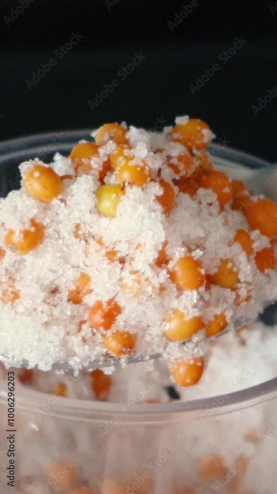 process of making jam from yellow sea buckthorn berries and sugar close-up. Healthy food and fruits for health and figure process of making jam from yellow sea buckthorn berries and sugar close-up. Healthy food and fruits for health and figure