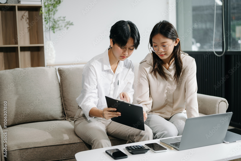 Portrait of success business people working together in office. Couple teamwork startup concept on sofa Portrait of success business people working together in office. Couple teamwork startup concept on sofa
