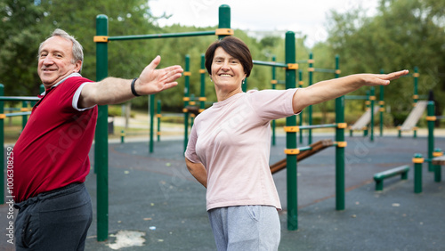 Sports pensioners do a warm-up on outdoor sports ground photo