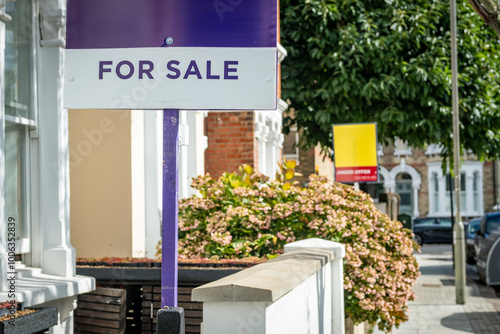 London- For Sale sign on street of terraced houses