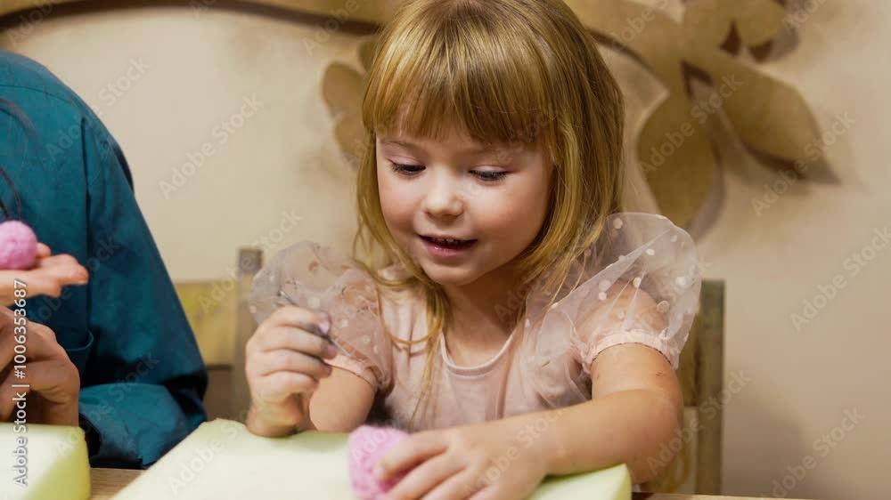 Girl engages in creative art activity with colorful materials at home Girl engages in creative art activity with colorful materials at home