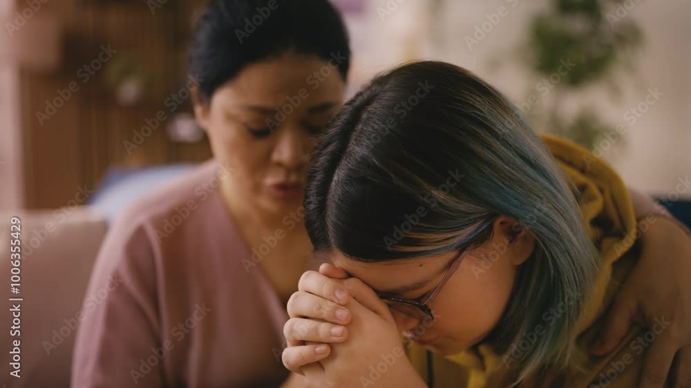 Caring Asian mother consoling and hugging her sad teenage girl, broken heart Caring Asian mother consoling and hugging her sad teenage girl, broken heart
