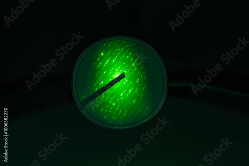 Crystallographic structure of crocidolite fibers (asbestos variety called blue asbestos) seen (diffracted light) on the green fluorescent screen of a Transmission Electron Microscope (TEM)