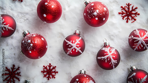 Christmas background with red ornaments and snowflakes on a white surface, flat lay top view