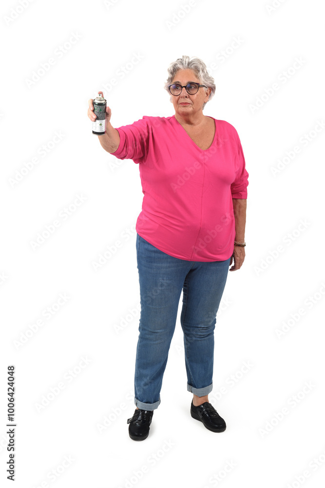 front view of a senior woman spray painting on white background front view of a senior woman spray painting on white background