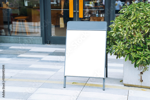 Obraz na płótnie Blank white outdoor advertising stand sandwich board mock up template. Clear street signage board placed by an outdoor dinning area of a restaurant. w salonie