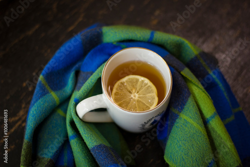 Cup of hot tea with lemon and coffin scarf.