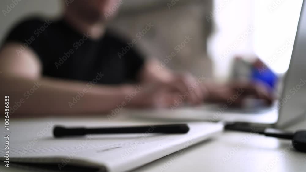 Man journaling thoughts into notebook Man journaling thoughts into notebook