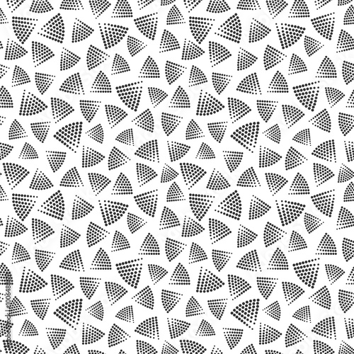 Triangular shapes from halftone dots grouped in  seamless pattern. Subtle surface art in black and white for use in fabric or graphic design or printing on various surfaces.
