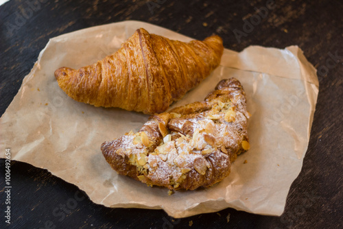 close-up of croissants stacked on wooden table.