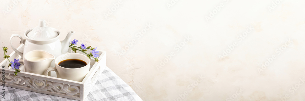 Chicory tea, teapot, milk jug on white wooden tray on plaid napkin. Banner. Copy space. Chicory tea, teapot, milk jug on white wooden tray on plaid napkin. Banner. Copy space.