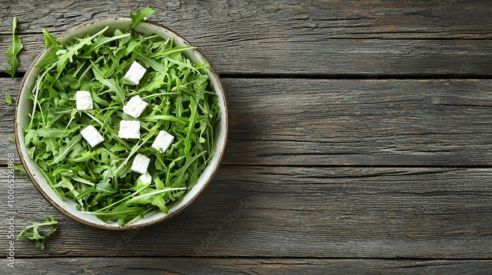 Fresh Arugula Salad with Feta Cheese on Rustic Wooden Table Fresh Arugula Salad with Feta Cheese on Rustic Wooden Table
