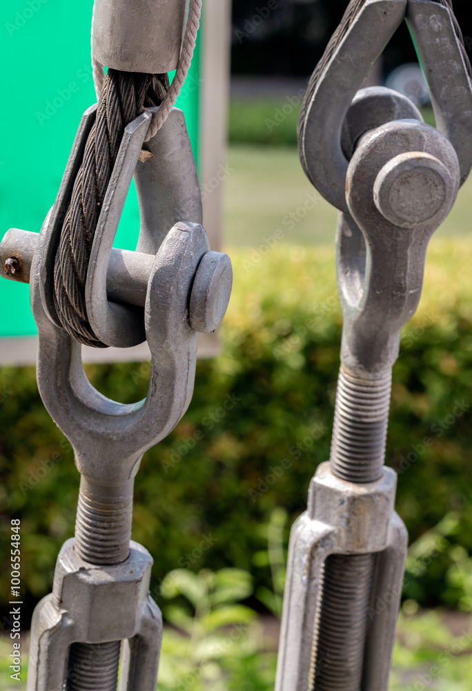 Metal ring and Steel cabling attached to a shackle. Steel wire rope slings with Thimble and safety anchor shackle turnbuckle connection bolt for heavy work, Device for adjusting the tension or length
