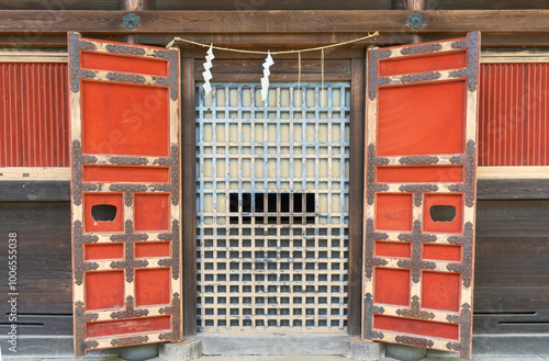 Traditional Japanese Shrine Entrance with Vibrant Red Doors