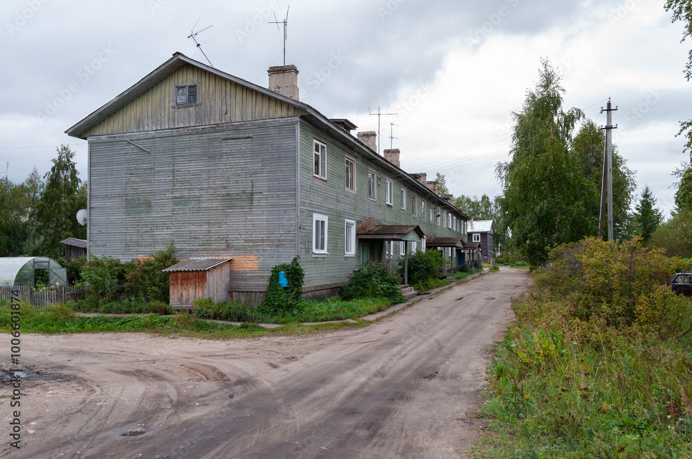Large typical two-storey wooden house in Kholmogory town, Arkhangelsk region, Russia Large typical two-storey wooden house in Kholmogory town, Arkhangelsk region, Russia