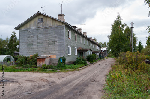 Large typical two-storey wooden house in Kholmogory town, Arkhangelsk region, Russia photo