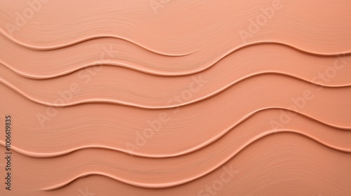 Liquid foundation makeup is forming wavy lines on a smooth surface, creating an abstract pattern. This background is perfect for beauty and cosmetics projects