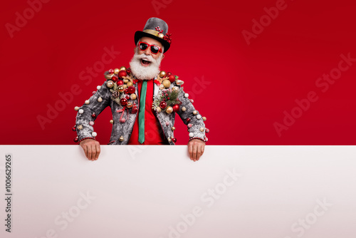 Photo of happy cheerful old man white banner sales wear christmas tree balls costume sunglasses isolated red color background photo