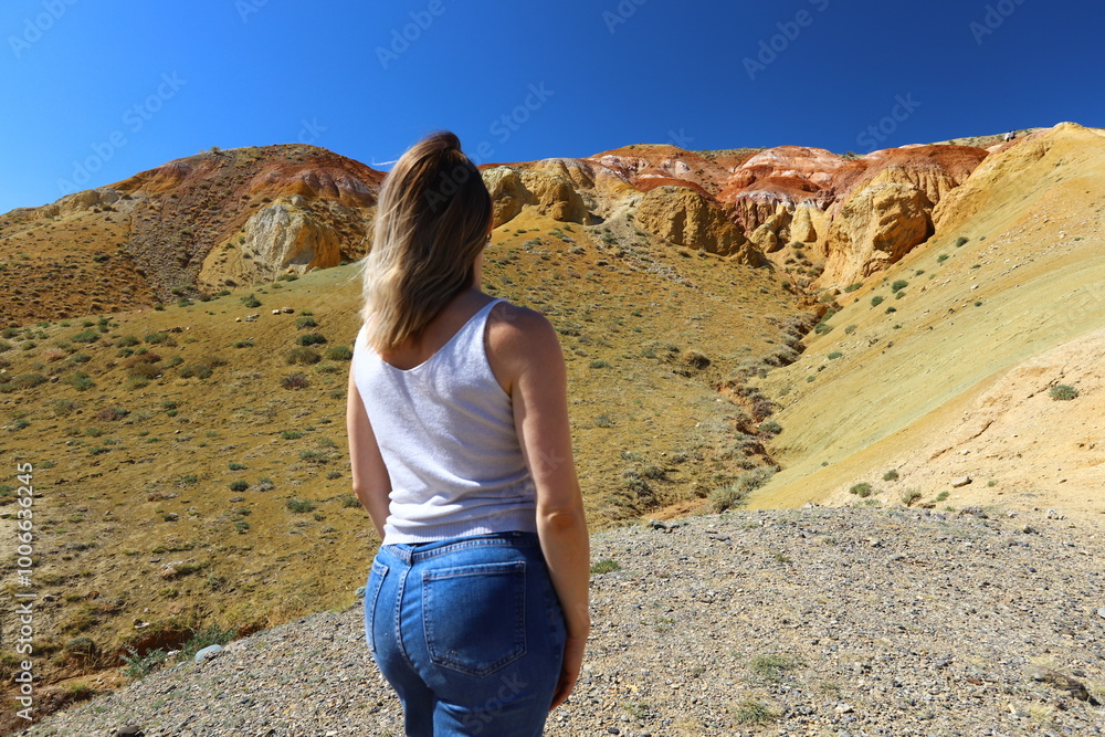 Naklejka premium Altai Republic. Tourists pose against the background of Martian and Moon landscapes – deserted area with canyons.