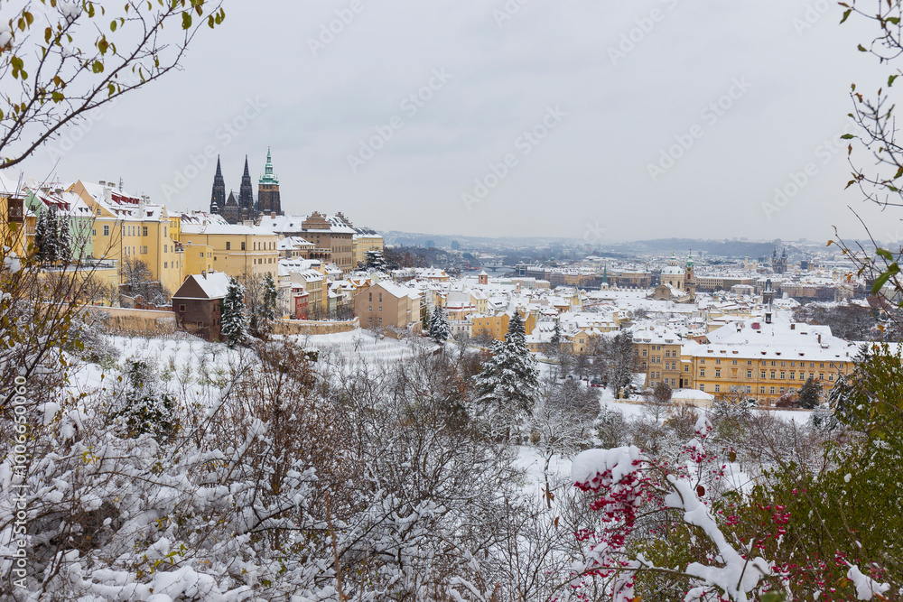 Snowy Prague City with gothic Castle from the Hill Petrin, Czech republic