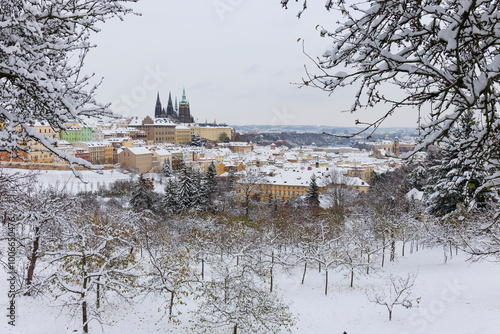 Snowy Prague City with gothic Castle from the Hill Petrin, Czech republic 