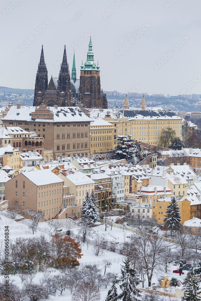 Snowy Prague City with gothic Castle from the Hill Petrin, Czech republic