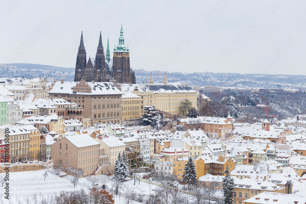 Snowy Prague City with gothic Castle from the Hill Petrin, Czech republic