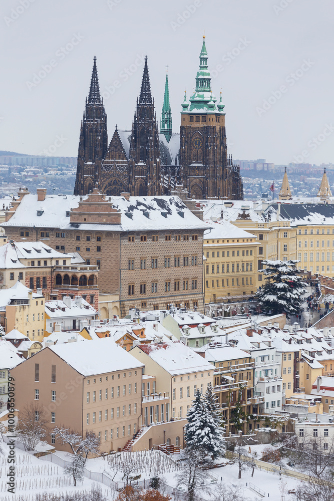 Snowy Prague City with gothic Castle from the Hill Petrin, Czech republic