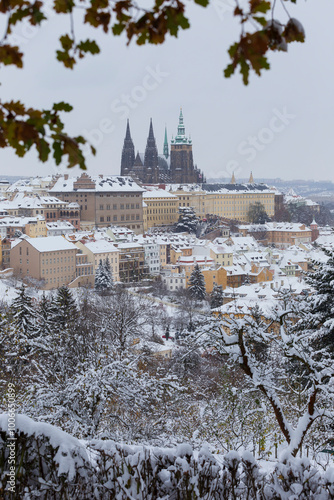Snowy Prague City with gothic Castle from the Hill Petrin, Czech republic 