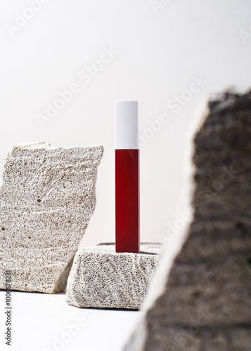 Elegant Red Lipstick Tube on White Stone Background - Minimalist Makeup Mockup photo