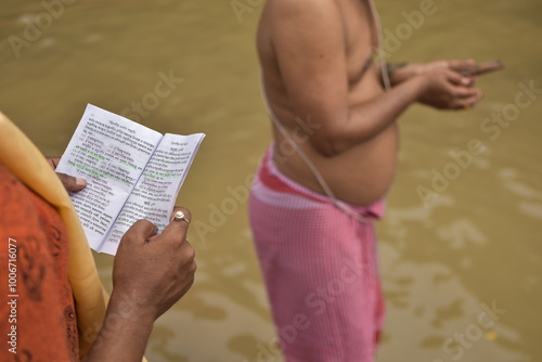 Tarpan is being performed by Indian hindu devotees on the banks of the holy river Ganga in Kolkata, India. In Hindu mythology this day is also called Mahalaya. photo