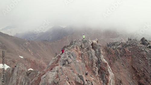 Mountaineers ascending Argualas and Algas Peak, surrounded by Garmo Negro and Los Infiernos: Impressive 4K aerial capture of a trekking day in the Aragonese Pyrenees. photo