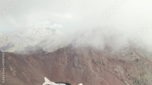 Epic ascent to Argualas Peak and Algas in Aragon Pyrenees: Mountaineers in full ascent captured in 4K with drone, surrounded by Garmo Negro and Los Infiernos in Panticosa Valley. photo