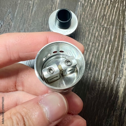 hand holding a metal can