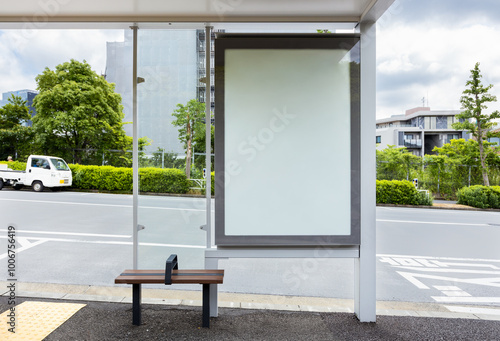 Photography Vertical blank billboard at a bus stop shelter on a street in Tokyo, near by a park